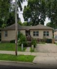Madison triplex for rent - a house on the side of the street in a neighborhood