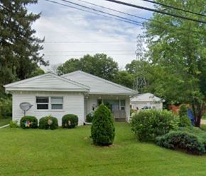 Madison triplex for rent - a white house with a yard and some bushes