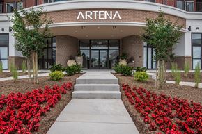 Manassas Park apartment for rent - an office building with a walkway and red flowers in front of it