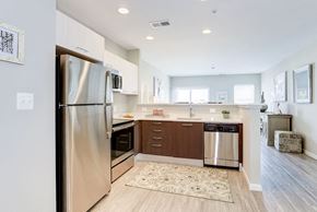 Manassas Park apartment for rent - a renovated kitchen with stainless steel appliances and wooden floors