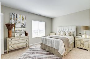 Manassas Park apartment for rent - a bedroom with a bed and a dresser