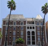Los Angeles apartment for rent - a large building with palm trees in front of it