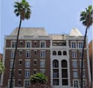 Los Angeles apartment for rent - a large building with palm trees in front of it