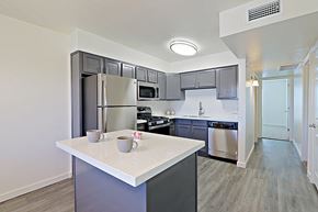Tempe apartment for rent - a kitchen with stainless steel appliances and white countertops