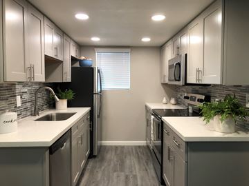 Tempe apartment for rent - a kitchen with stainless steel appliances and white counter tops