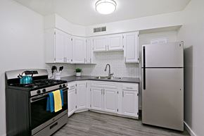 Phoenix apartment for rent - a kitchen with stainless steel appliances and white cabinets