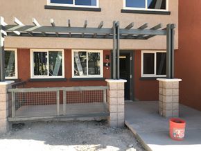 Las Vegas apartment for rent - a building with a ramp and a fence in front of it