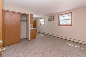 Princeton apartment for rent - an empty living room with a door to a closet and a window