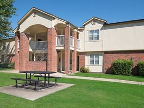 Harrison apartment for rent - a picnic table in front of an apartment building