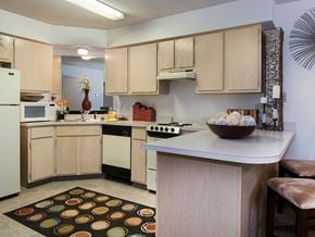 Harrison apartment for rent - a kitchen with white appliances and a counter with a bowl of cookies