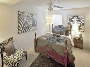 Siloam Springs apartment for rent - a bedroom with a bed and a ceiling fan