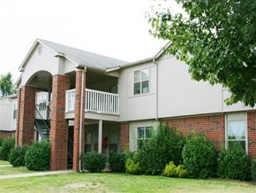Springdale apartment for rent - the exterior of an apartment building with a yard and a balcony