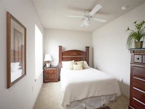Springdale apartment for rent - a bedroom with a large bed and a ceiling fan