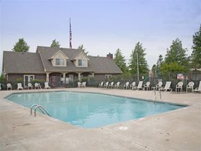Springdale apartment for rent - a swimming pool with chairs around it in front of a house