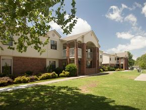 Springdale apartment for rent - an apartment building with a green lawn and a sidewalk