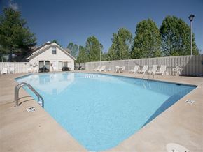 Springdale apartment for rent - a swimming pool with chairs and a fence around it
