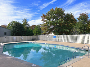 Springdale apartment for rent - a swimming pool with a white fence around it