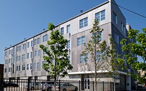 Chicago apartment for rent - a large building with cars parked in front of it