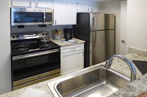 Nashville apartment for rent - a kitchen with a sink and a stove and a refrigerator