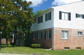 Flint apartment for rent - a brick and with a tree in front of it