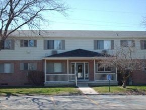 Flint apartment for rent - a white and brick house with a front porch
