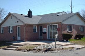 Flint apartment for rent - a red brick house with a parking meter in front