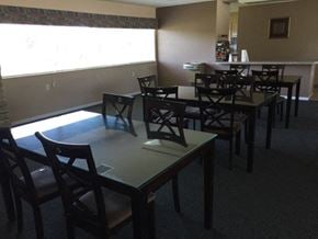 Mt. Morris townhouse for rent - a dining room with tables and chairs and a window