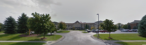Flushing townhouse for rent - the parking lot of a building with cars parked in front of it