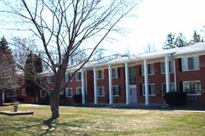 Flushing townhouse for rent - an apartment building with a tree in front of it