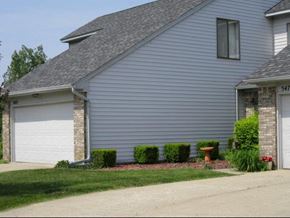 Grand Blanc condo for rent - a blue house with a white garage door