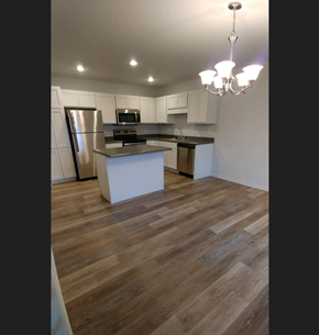 Grand Blanc condo for rent - a renovated kitchen with white cabinets and stainless steel appliances