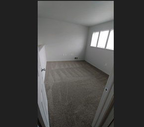 Grand Blanc condo for rent - the bedroom has a carpeted floor and a window