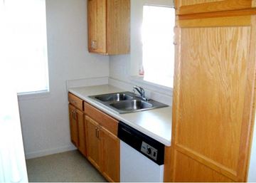 Flint townhouse for rent - a small kitchen with a sink and a refrigerator