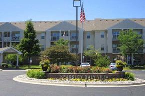 Flint townhouse for rent - a large building with an flag in front of it