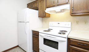 Holland apartment for rent - a kitchen with white appliances and wooden cabinets and a refrigerator