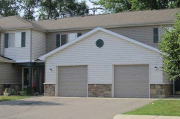 Flint townhouse for rent - a white house with two garage doors