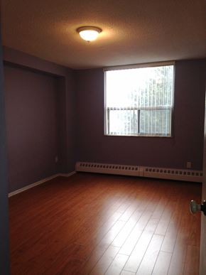 Toronto apartment for rent - A room with a window and a wooden floor.