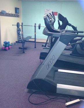 Toronto apartment for rent - A treadmill with a sign on the wall behind it.