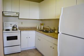 Toronto apartment for rent - a kitchen with white appliances and white cabinets