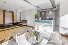 Toronto apartment for rent - A reception area with a bench, a plant, and a counter.