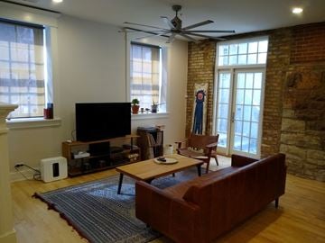 Chicago apartment for rent - a living room with a leather couch and a television