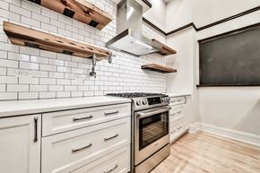 Chicago apartment for rent - a kitchen with white cabinets and stainless steel appliances