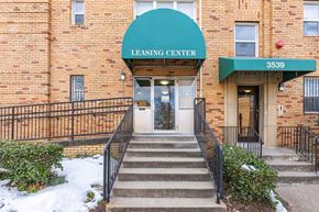 Washington apartment for rent - A brick building with a green awning that says Leasing Center.