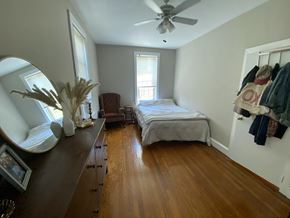 Philadelphia apartment for rent - a bedroom with a bed and a dresser and a mirror