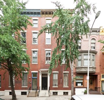 Philadelphia apartment for rent - A red brick building with a tree in front of it.