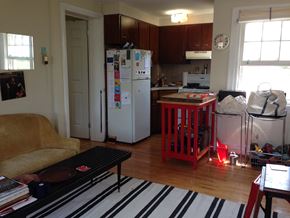 Philadelphia apartment for rent - the kitchen and living room is cluttered with boxes and a rug