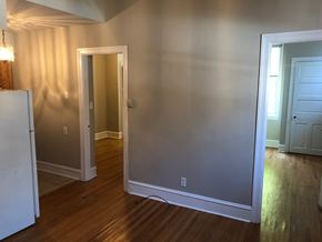 Philadelphia apartment for rent - an empty living room with a door open to a hallway