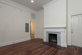 Philadelphia apartment for rent - a living room with a fireplace and a door to a bathroom