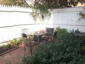 Philadelphia apartment for rent - a patio with a table and chairs in a backyard