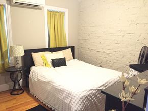Philadelphia apartment for rent - a bedroom with a bed and a white brick wall